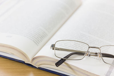 High angle view of eyeglasses and book on table