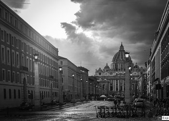 Street amidst buildings against sky in city