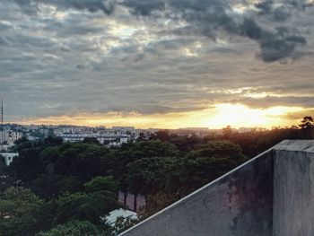 Buildings against cloudy sky at sunset