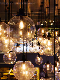 Close-up of illuminated lights hanging on ceiling