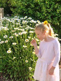 Girl standing by plants