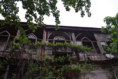 Low angle view of built structure against trees