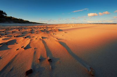 Scenic view of beach against sky during sunset