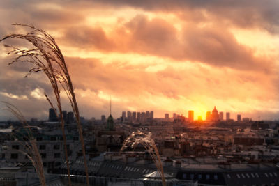 High angle view of buildings in city during sunset