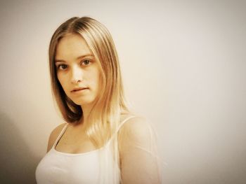 Portrait of beautiful young woman against white background