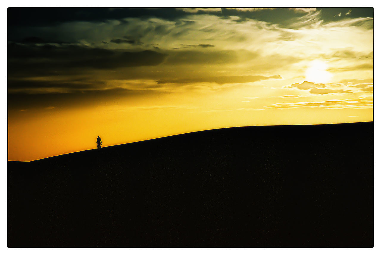 sunset, silhouette, sky, scenics, tranquil scene, transfer print, tranquility, beauty in nature, orange color, cloud - sky, nature, auto post production filter, idyllic, dramatic sky, outline, cloud, landscape, dark, unrecognizable person, dusk