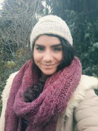 Portrait of smiling woman in park during winter