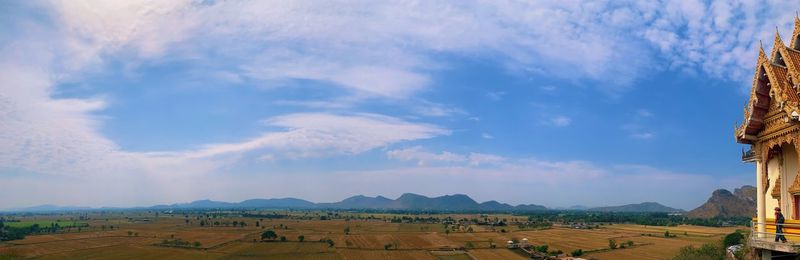 Panoramic view of agricultural field against sky