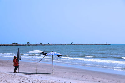 Scenic view of beach against clear sky