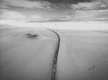 Aerial view of land and road against sky