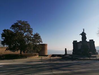 Silhouette of statue against blue sky