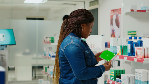 Side view of young woman standing at airport