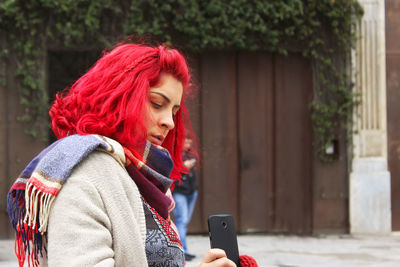 Girl with red hair on the street take photo