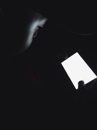 Close-up of human face over black background