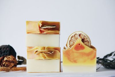 Close-up of fruit on table against white background