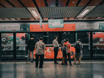 Rear view of people at subway station