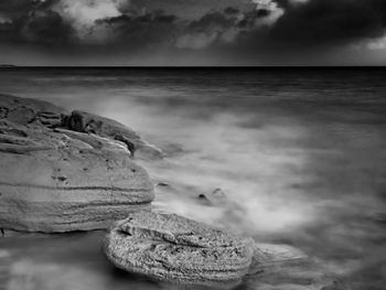 Scenic view of sea against cloudy sky