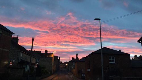 Residential buildings against sky during sunset