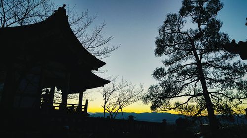 Low angle view of built structure at sunset