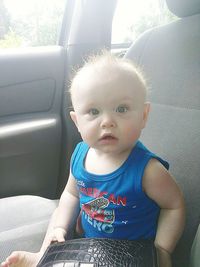 Portrait of cute girl sitting in car