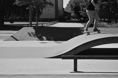 Rear view of woman walking on skateboard