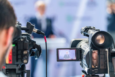 Side view of man holding camera