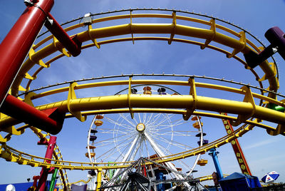 Low angle view of ferris wheel against sky