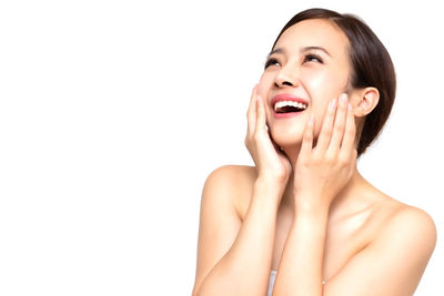 Portrait of a smiling young woman over white background