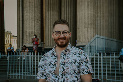 Portrait of smiling young man standing outdoors