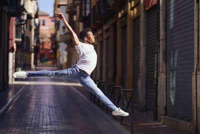 Rear view of man skateboarding on wall