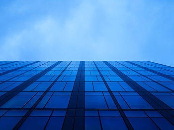 Low angle view of modern building against blue sky