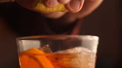 Close-up of woman holding glass