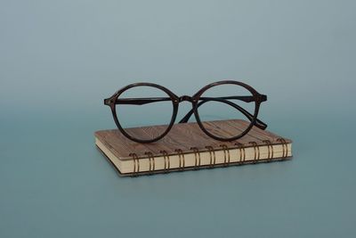High angle view of eyeglasses on table against blue background