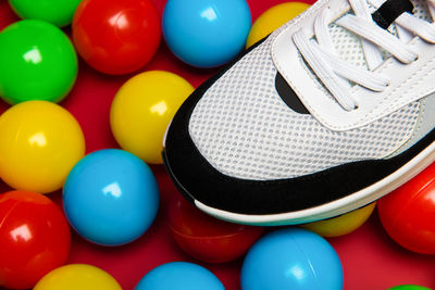 High angle view of shoe on multi colored balls