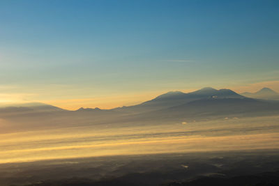 Scenic view of silhouette mountains against sky during sunset