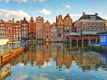 Reflection of buildings on canal in city