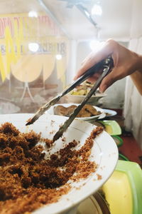 Close-up of person preparing food on table