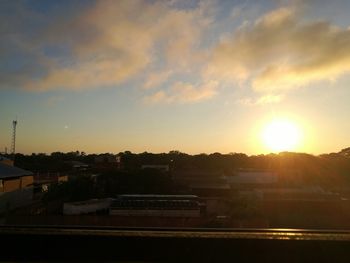 Silhouette buildings against sky during sunset