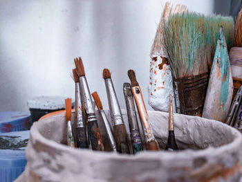 Close-up of paintbrushes in container