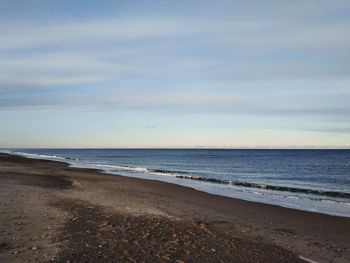 Scenic view of beach against sky during sunset