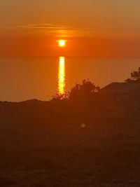 Scenic view of sea against romantic sky at sunset