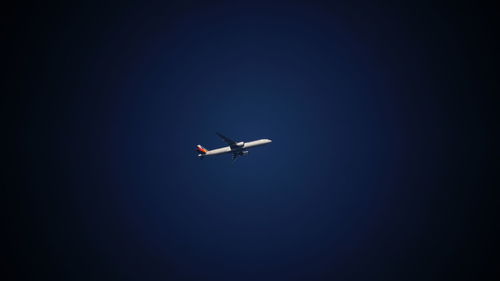 Low angle view of airplane flying in sky