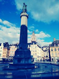 Low angle view of statue against cloudy sky