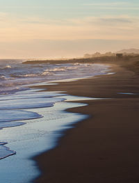 Scenic view of beach against sky during sunset