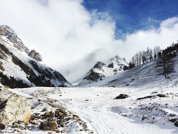 Scenic view of snow covered mountains against sky