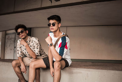 Young couple sitting on wall