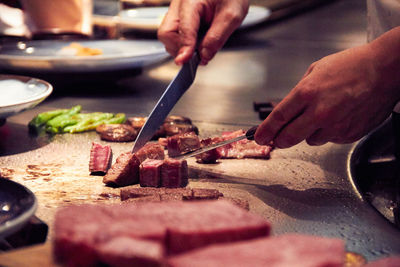 Close-up of man preparing food on cutting board