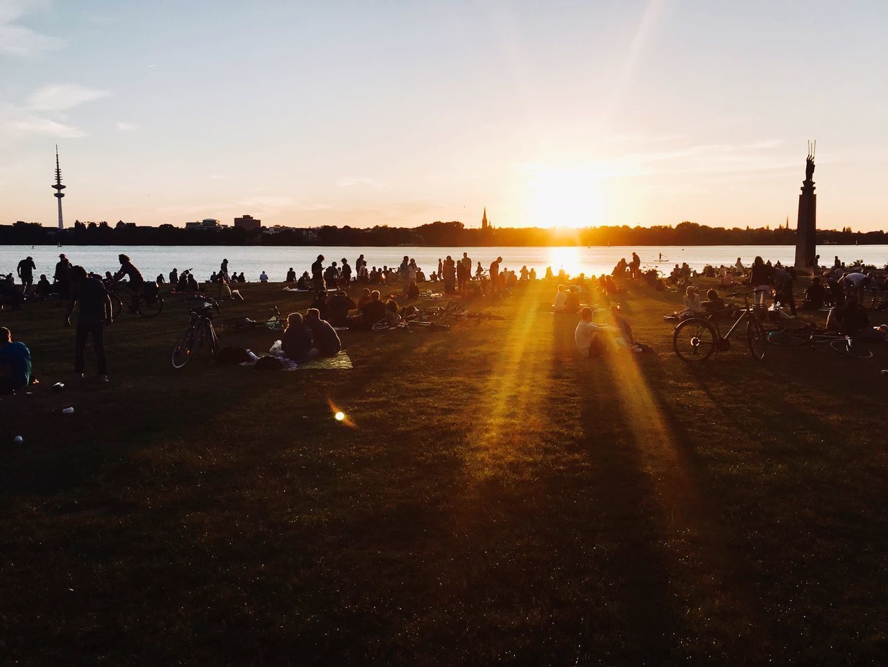 PEOPLE ON FIELD AGAINST SKY DURING SUNSET