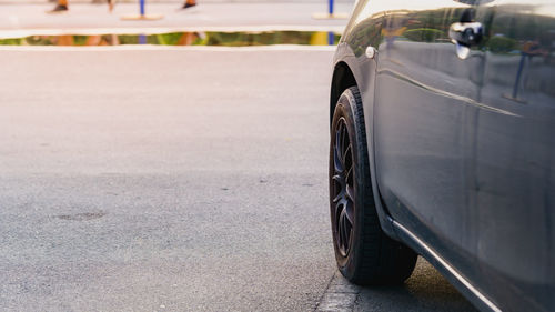 Black car side photo and soft focus background.