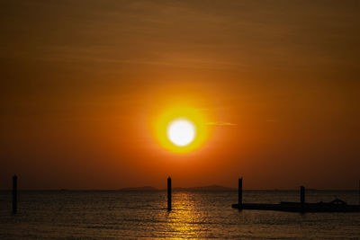 Scenic view of sea against orange sky